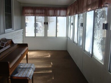 ENCLOSED FRONT PORCH, OVER LOOKING RESERVOIR.