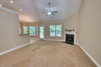 Unfurnished living room featuring baseboards, carp
