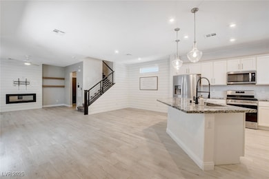 Kitchen with stainless steel appliances, light sto