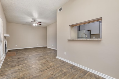Unfurnished living room with a ceiling fan, a text