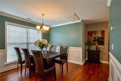 Formal dining room with hardwood flooring and wonderful detailed trim work.  