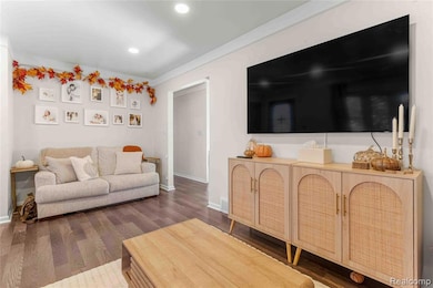 Living area with dark wood-style flooring and recessed lighting