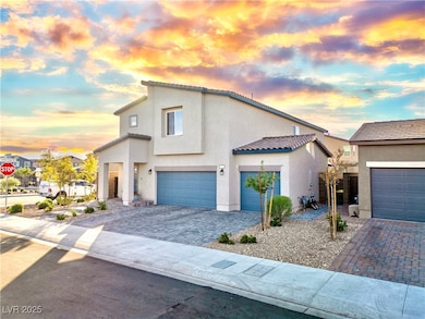 View of front of house featuring stucco siding, a tiled roof, and decorative driveway
