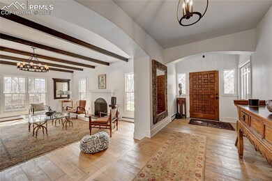 Living room with beamed ceilings and lots of windo