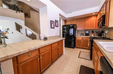 Gourmet kitchen features extended cabinets, tile,