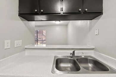 Kitchen view of a textured wall and light countertops