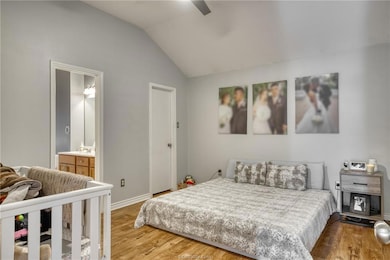 Bedroom with baseboards, a ceiling fan, connected