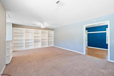 Unfurnished living room featuring light carpet, ce