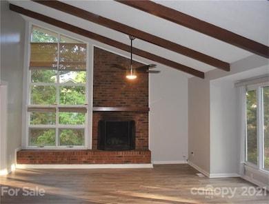 Living Room with vaulted ceiling and wood burning 