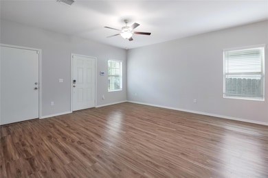 Empty room featuring ceiling fan and wood finishe