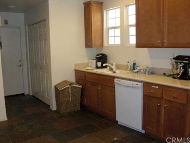Kitchen includes Slate floors, wood cabinetry, and