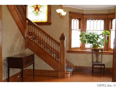 Foyer. Polished woodwork and flooring make an eleg