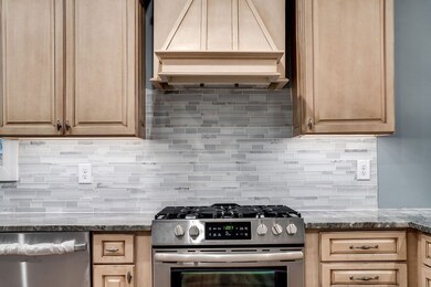 Gas Stove and tile backspace along with under the counter lighting makes for easy cooking.