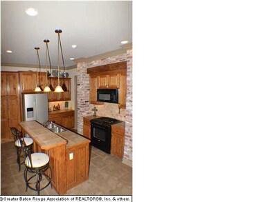 Kitchen Features Custom Cabinets, Black Appliances