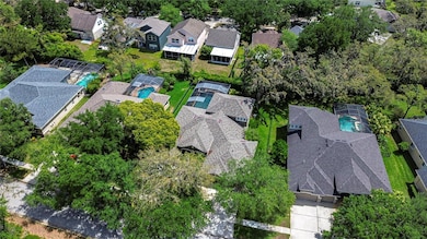 Nestled in a verdant neighborhood, this picturesque home boasts a private screened pool