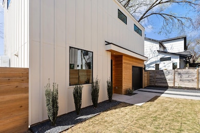 View of home's exterior with a garage and fence