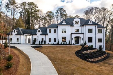 French country home featuring stucco siding and cu