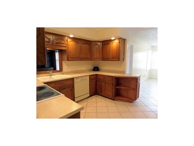Appliances include a smooth surface range, double 
