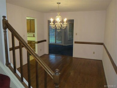 Dining room with fancy chandelier, hardwoods and c