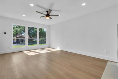 Empty room with wood finished floors, recessed li