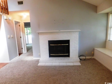 Detailed view of carpet floors and a fireplace