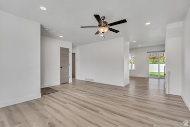 Unfurnished room with light wood-style floors, recessed lighting, and a ceiling fan