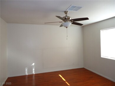Spare room featuring visible vents, ceiling fan, b