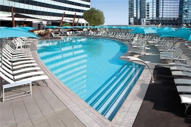 Community pool with a patio area and a view of city