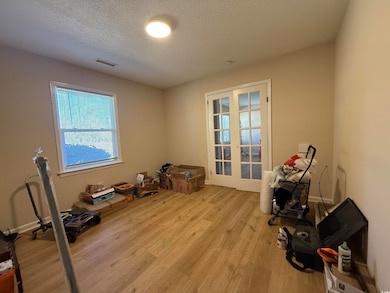 Miscellaneous room featuring a textured ceiling, l