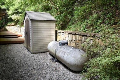 Propane tank and tool shed in the back