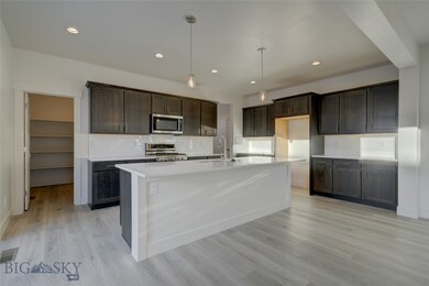 Kitchen featuring pendant lighting, an island with