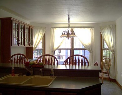 Kitchen. This roomy kitchen boasts oak cabinets and a 3 person breakfast bar/counter.  Perfect for a quick snack and entertaining.