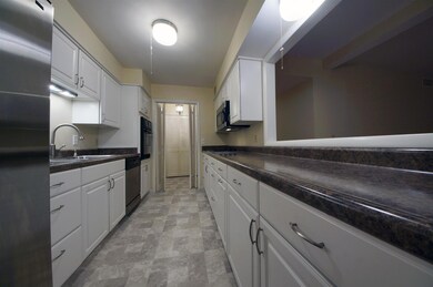 The charming pass-through window opens up the Kitchen without compromising storage or counter space.