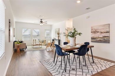 Dining area featuring wood finished floors, a cei