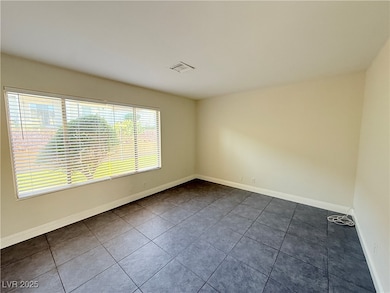 Tiled spare room with baseboards