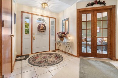 Tiled entryway featuring french doors