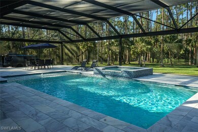 View of pool featuring glass enclosure, a patio, a