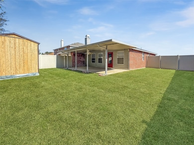 Back of house with a patio area, a fenced backyard, a chimney, ceiling fan, and a storage shed