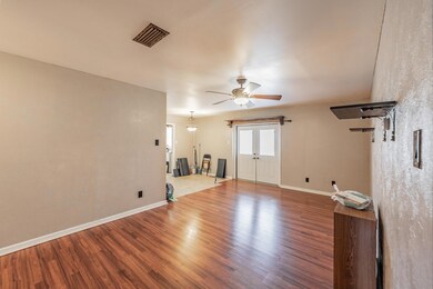 Unfurnished room with ceiling fan and wood-type fl
