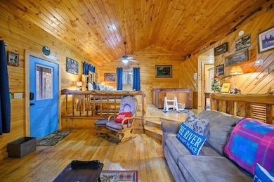 Living room with wood ceiling, light hardwood / wo
