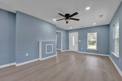 Unfurnished living room featuring hardwood / wood-