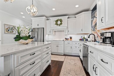 Kitchen featuring light stone countertops, white c