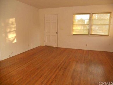 Living room and front door.  Newly refinished hard
