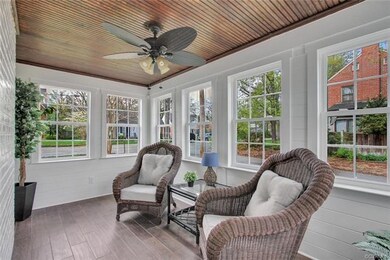 SUNROOM off of the formal living/dining area...this could also be the perfect study boasting new wall trim detail, ceramic wood flooring & windows w original tongue & groove ceiling