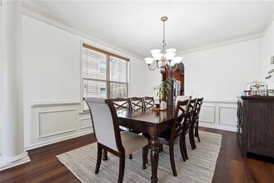 Dining space featuring a wainscoted wall, a notabl