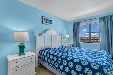 Bedroom featuring a textured ceiling and tile patt