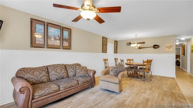 Open floor plan flows from living to dining into k