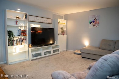 Living room featuring carpet floors and baseboards
