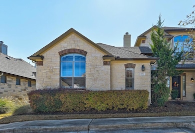 View of front facade with stone siding and a chim