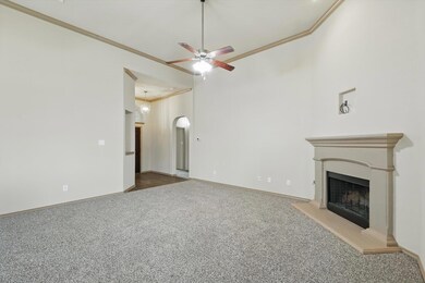 Unfurnished living room featuring crown molding, a